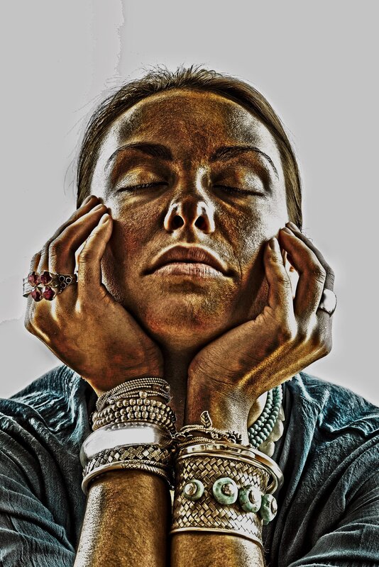 woman with eyes closed and hands on face