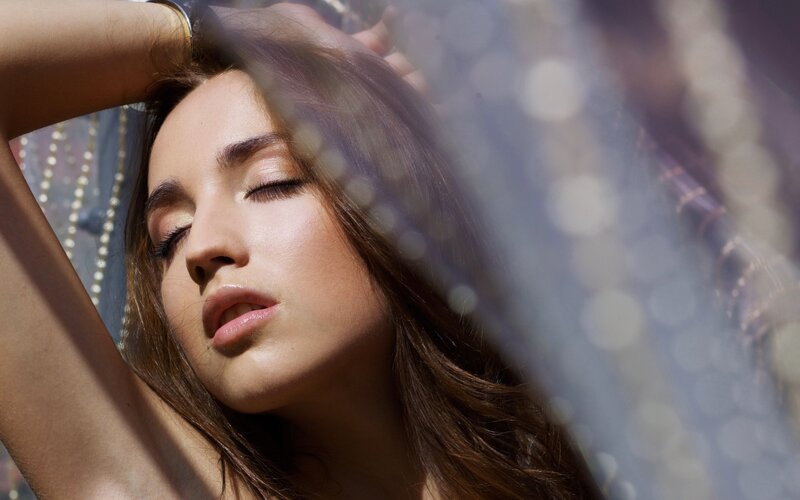 woman with eyes closed in sunlight