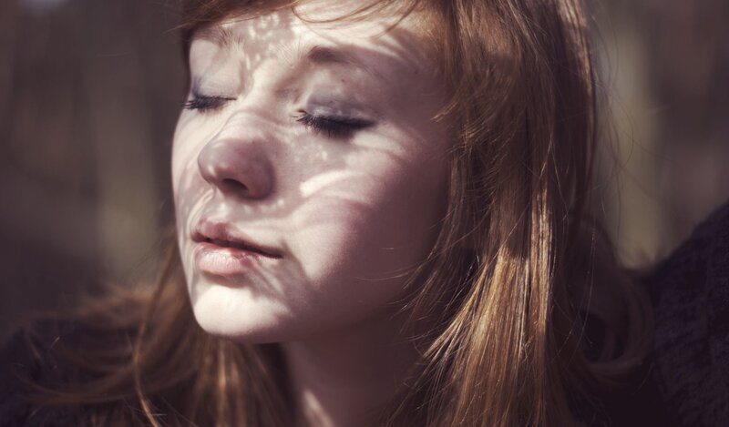 woman with eyes closed in sunlight