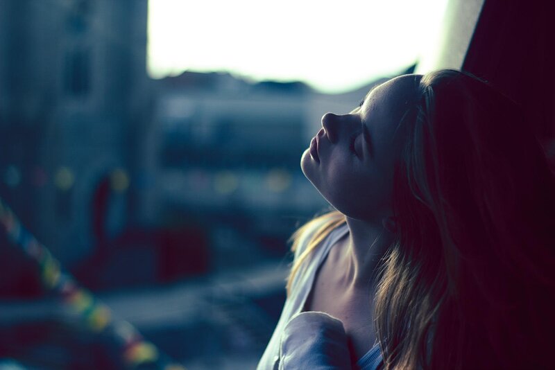 woman with eyes closed in sunlight
