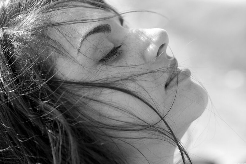 woman with eyes closed in sunlight