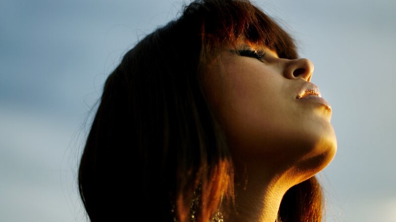 woman with eyes closed in sunlight
