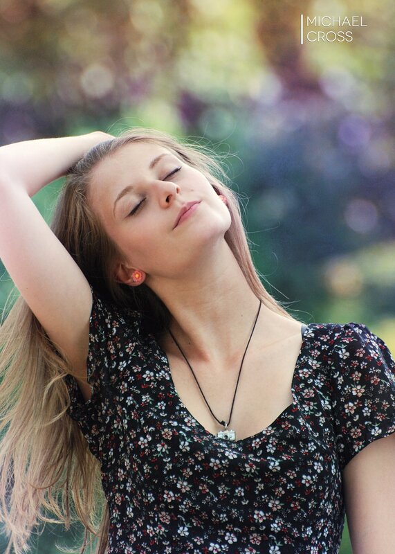 woman with eyes closed outdoors