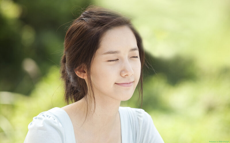 woman with eyes closed outdoors