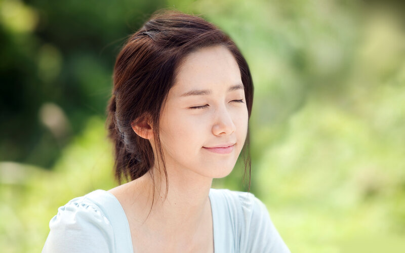 woman with eyes closed outdoors