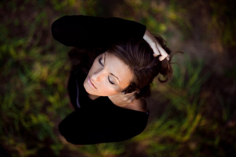 woman with eyes closed outdoors