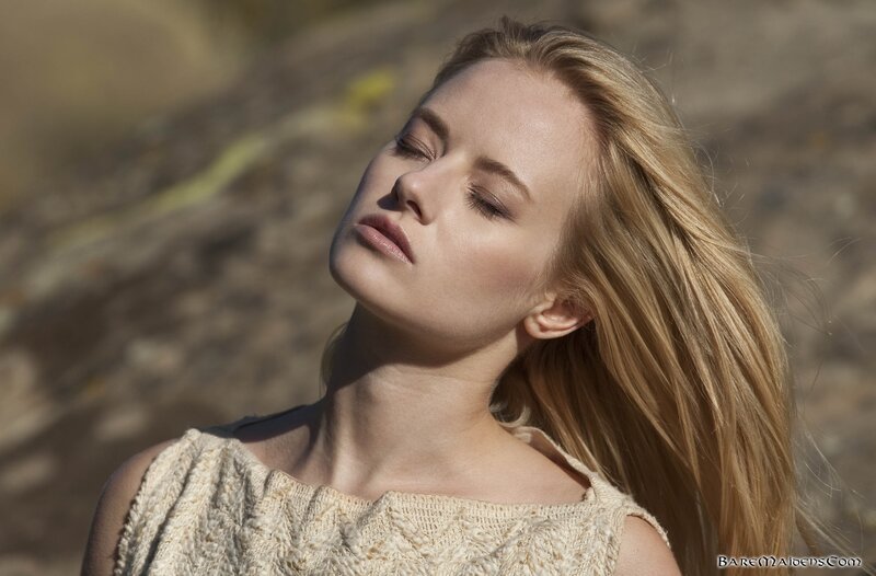 woman with eyes closed outdoors