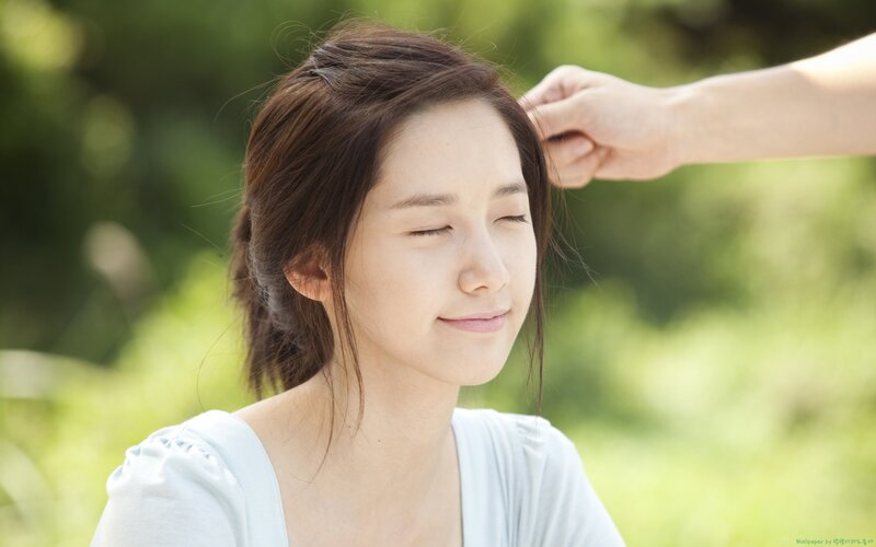 woman with eyes closed outdoors