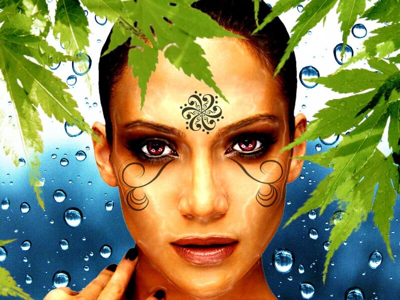 woman with face art and leaves