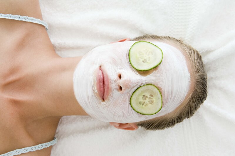 woman with face mask and cucumber