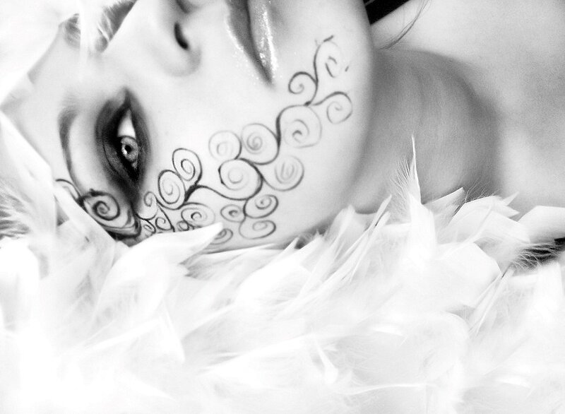 woman with face paint and feathers