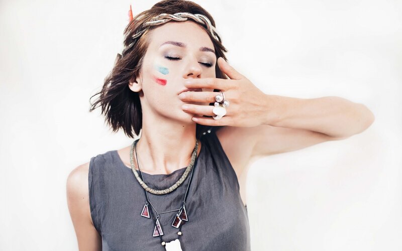 woman with face paint and jewelry