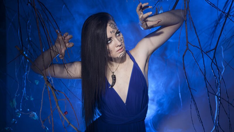 woman with face paint in blue setting