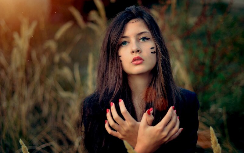 woman with face paint in field