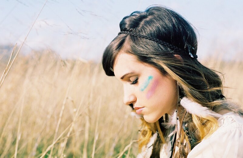woman with face paint in field