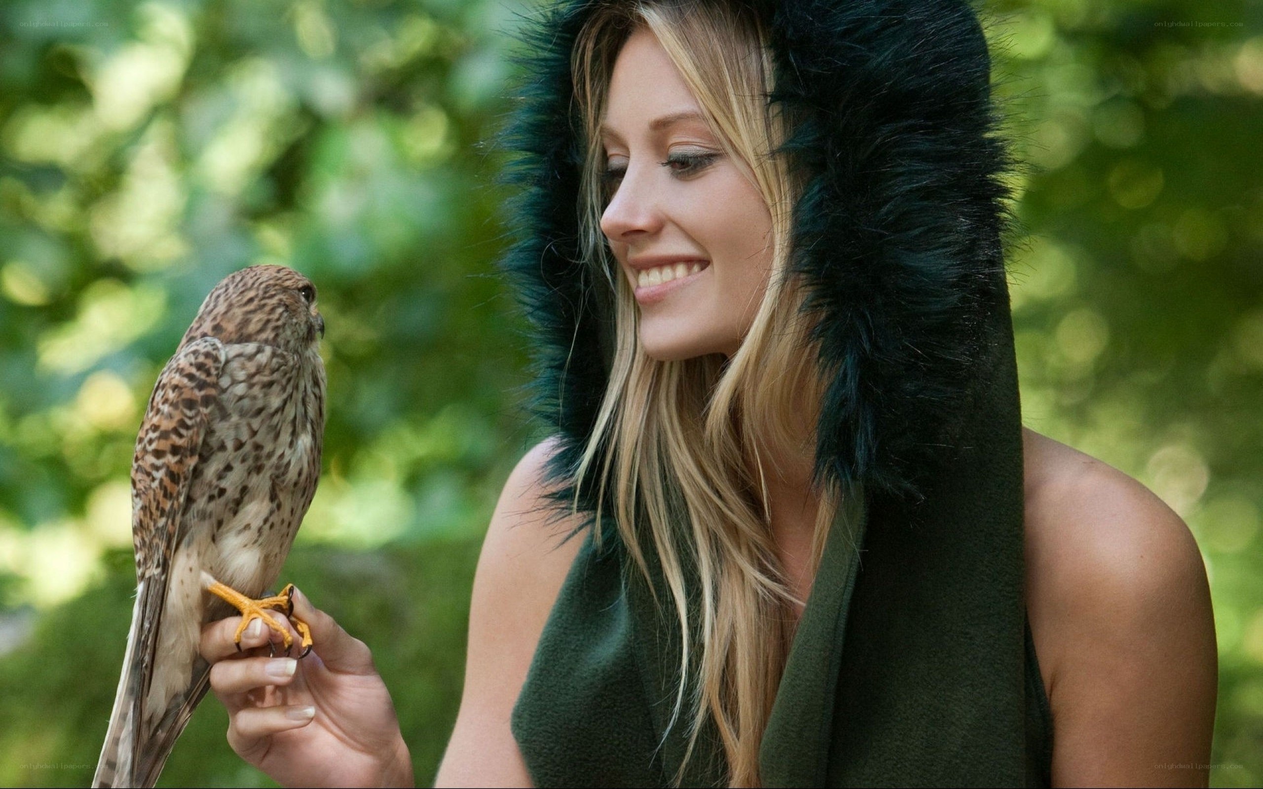 Woman with falcon in forest