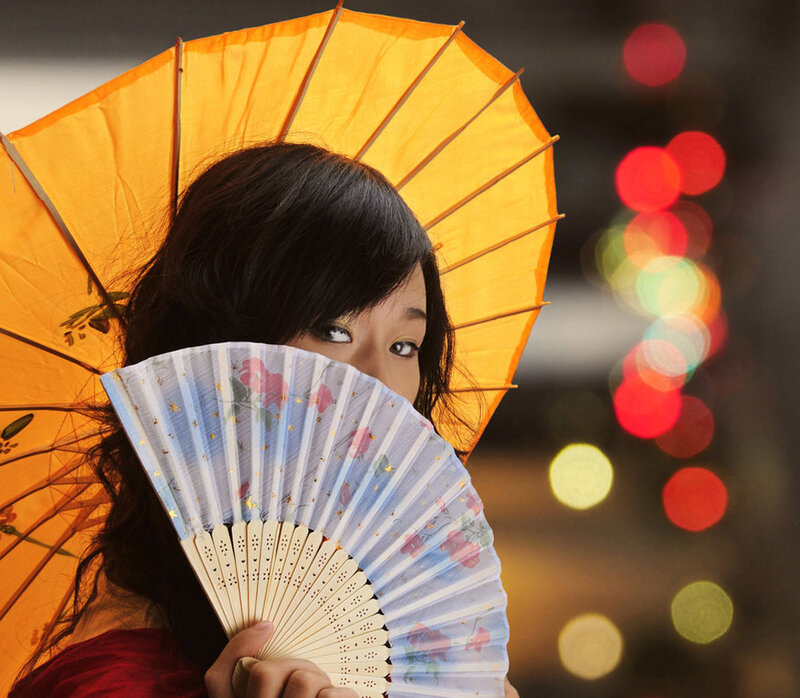 woman with fan and umbrella