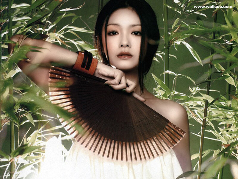 woman with fan in bamboo