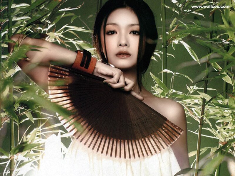 woman with fan in bamboo