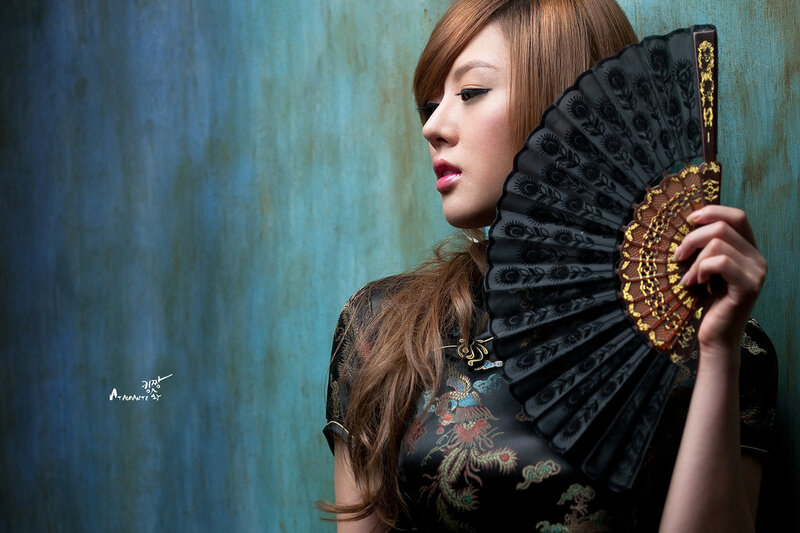 woman with fan in traditional dress