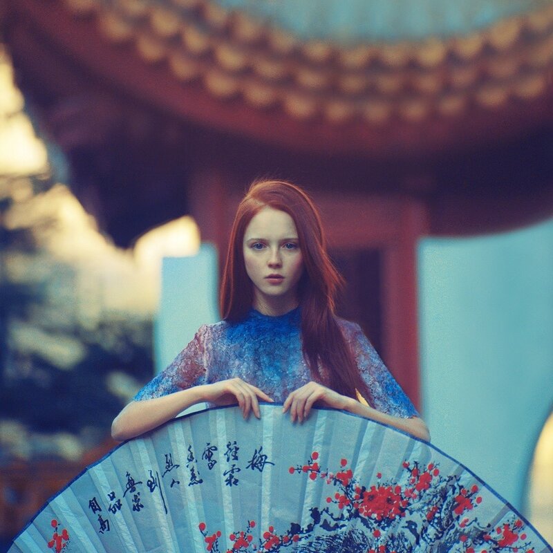 Woman with fan in traditional setting