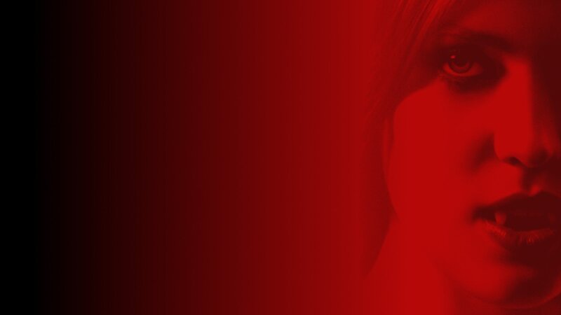 woman with fangs in red light