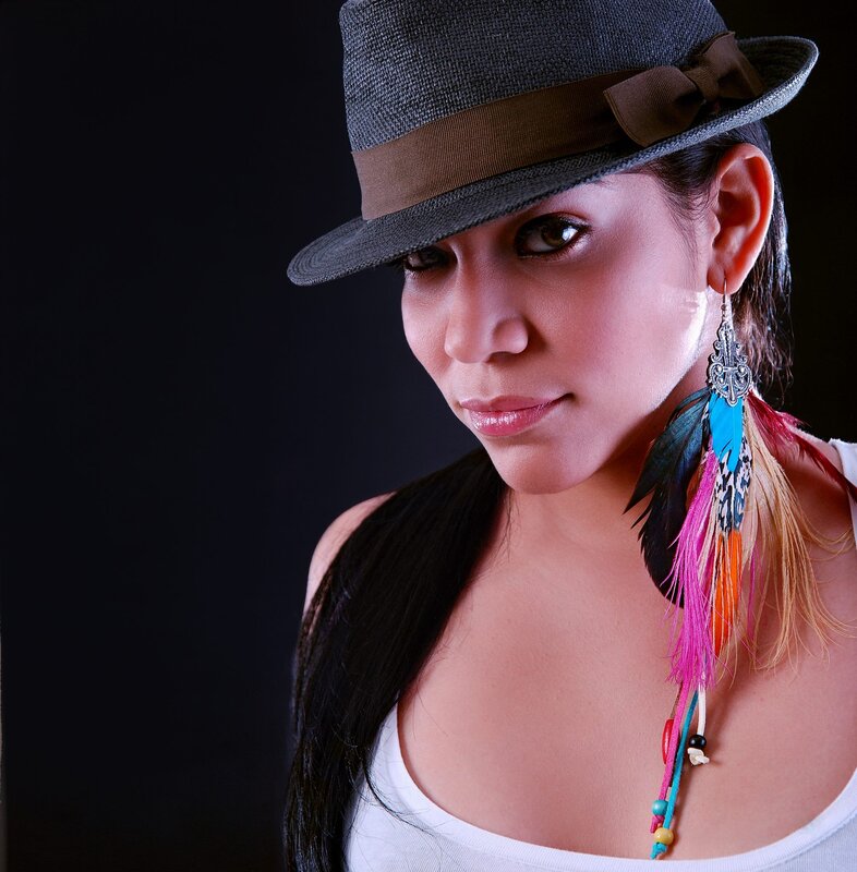 woman with feather earring and hat