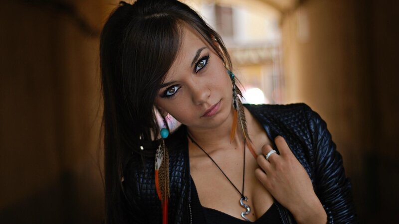 woman with feather earrings