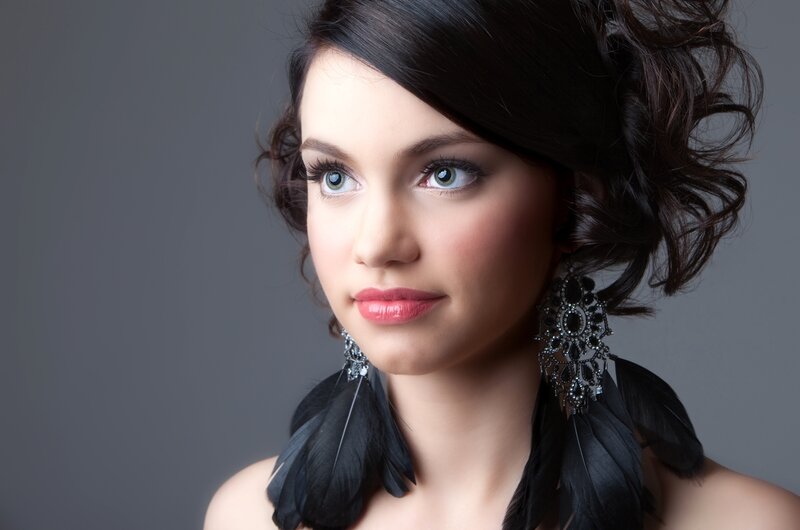woman with feather earrings