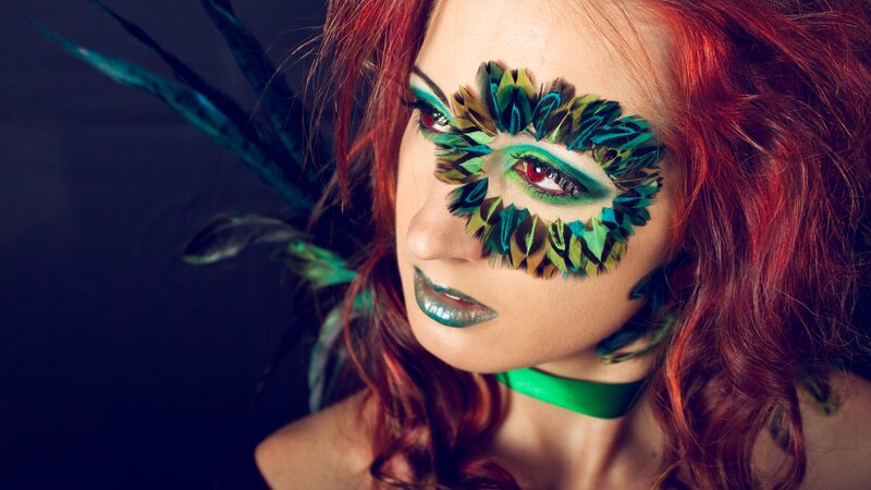 woman with feather eye mask
