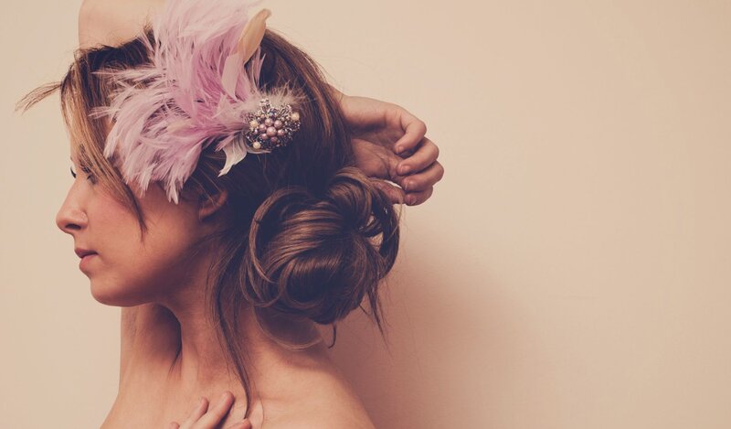 woman with feather hair accessory