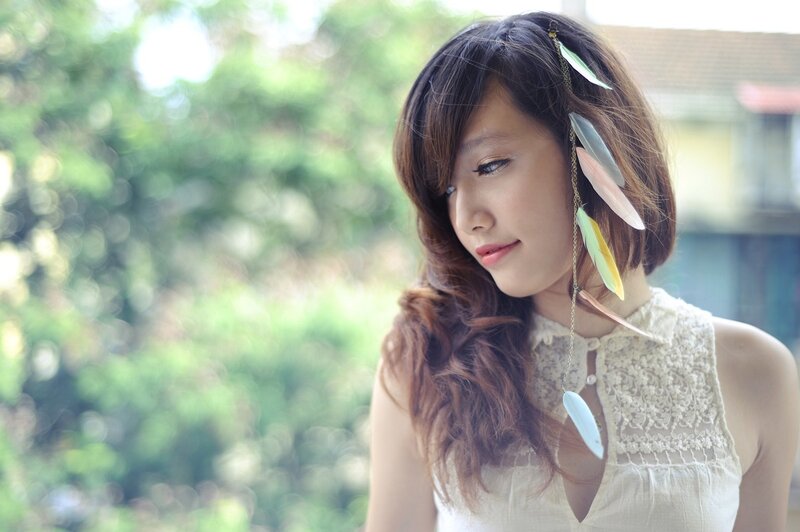woman with feather hair accessory