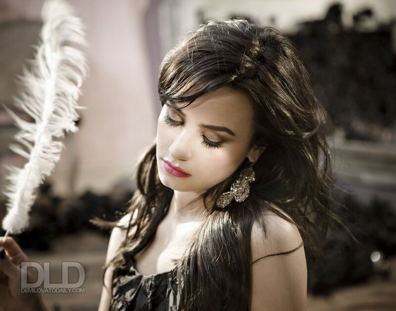 woman with feather in hand