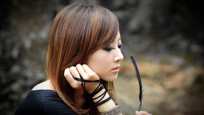 woman with feather in profile
