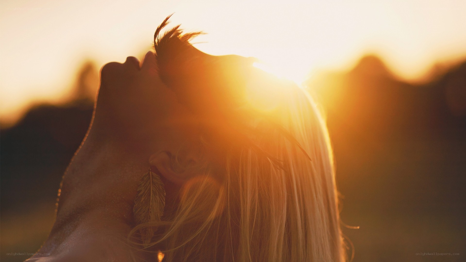 woman with feather in sunset