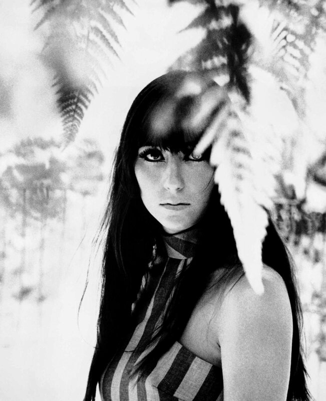 woman with fern in foreground