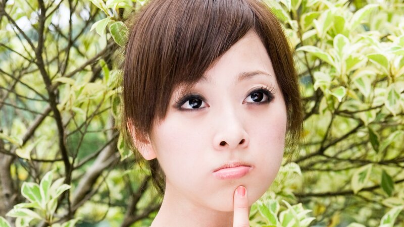 woman with finger on chin