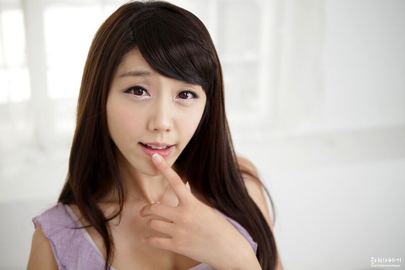 woman with finger on lip