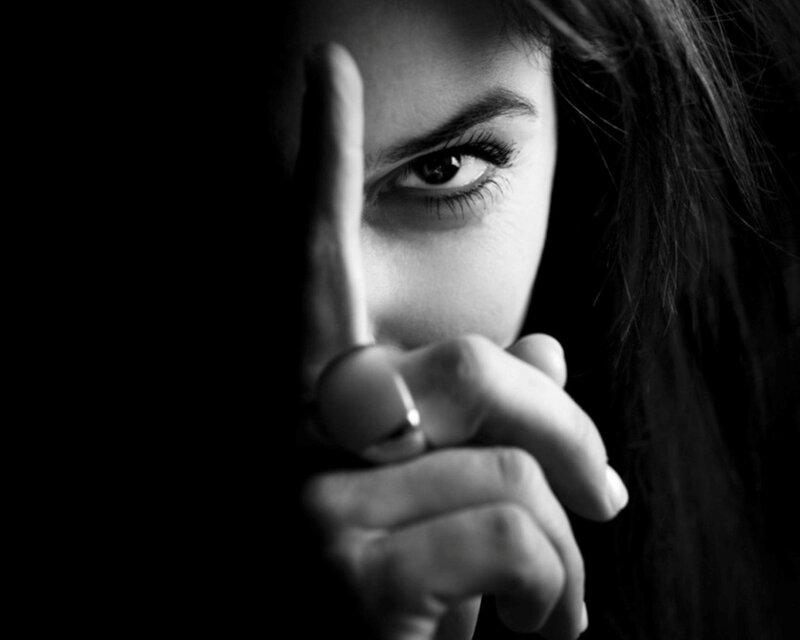 woman with finger to face