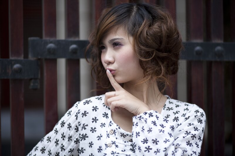 woman with finger to lips