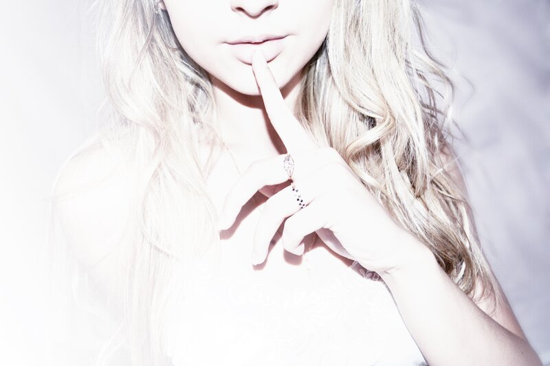 woman with finger to lips