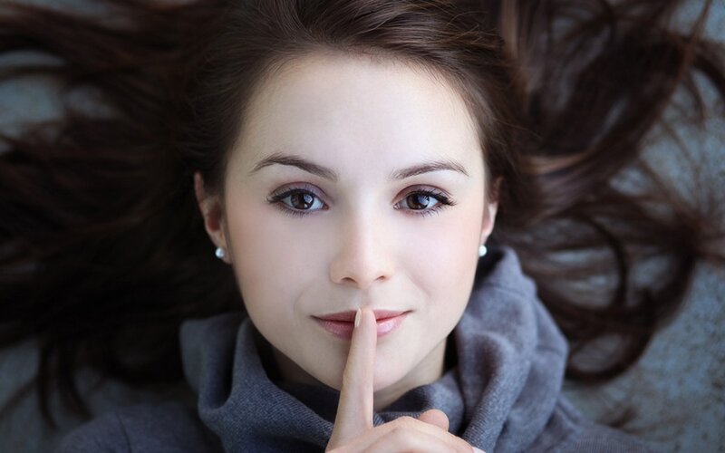 woman with finger to lips