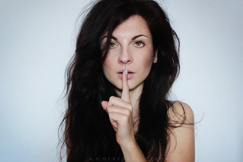 woman with finger to lips