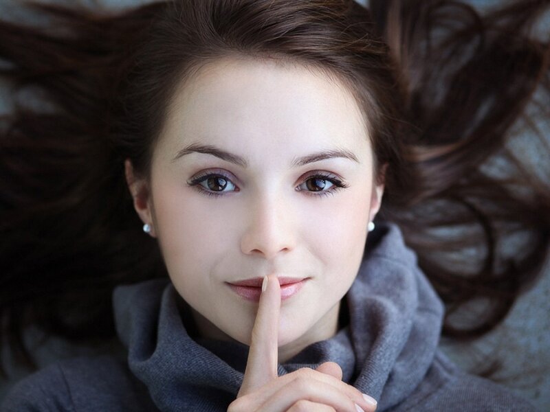 woman with finger to lips