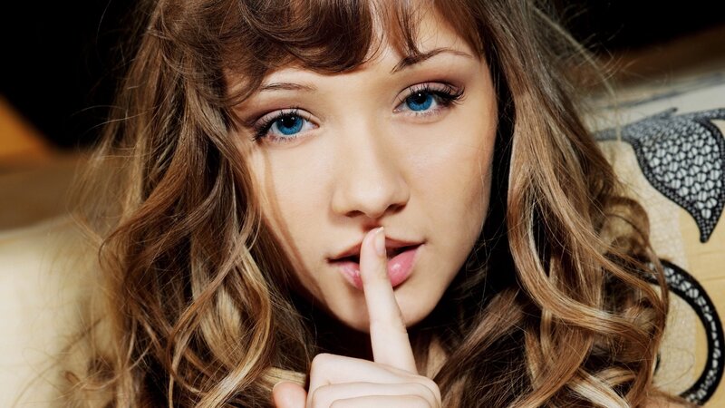 woman with finger to lips