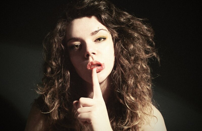 woman with finger to lips