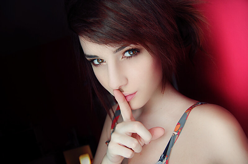 woman with finger to lips