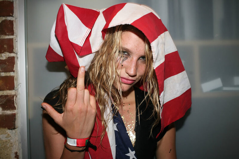 woman with flag and middle finger