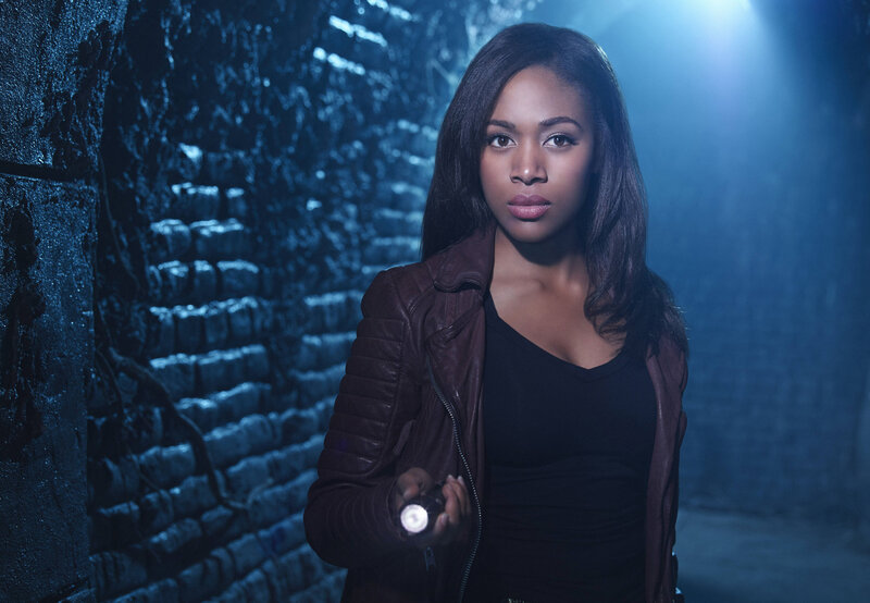 woman with flashlight in tunnel