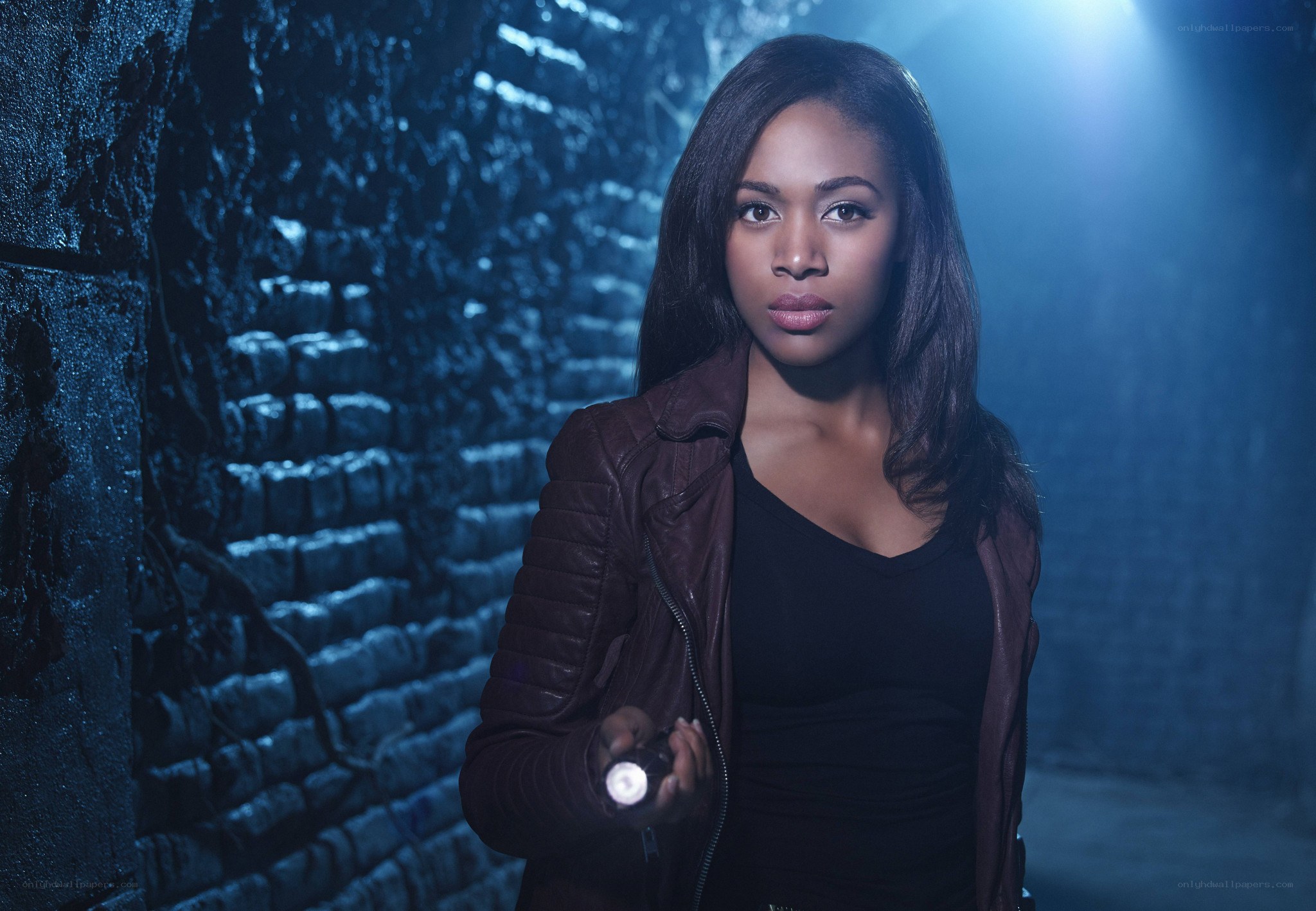 woman with flashlight in tunnel